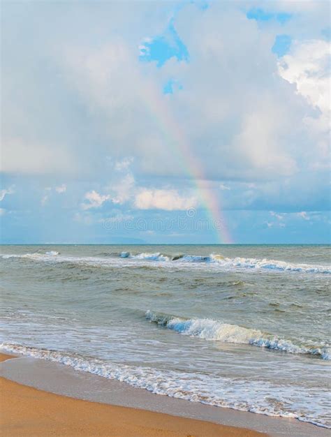 Rainbow In The Cloudy Sky Over The Sea View From The Beach Stock