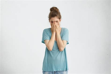 Free Photo Disappointed Dejected Female With Hair Bun Wearing Blue