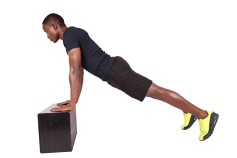 Fitness Man Doing Incline Push Ups On Black Box