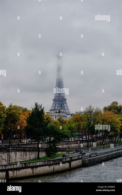 Cool And Rainy Day In Paris Eiffel Tower In The Fog Seine River In