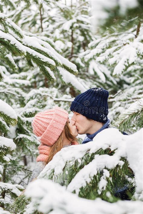 Couple Kissing Among Snowy Fir Trees Stock Photo Image Of Blonde