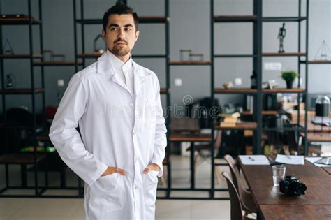 Portrait Of Thoughtful Male Doctor Wearing White Medical Uniform