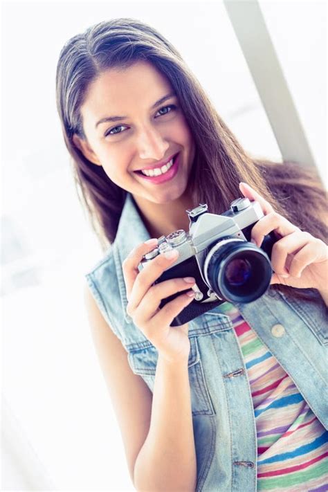 Smiling Young Woman Holding Her Camera Stock Photo Image Of Length