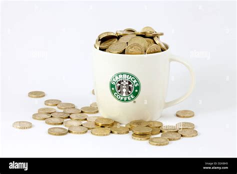 A Starbucks cup or Starbucks mug overflowing with money - pounds