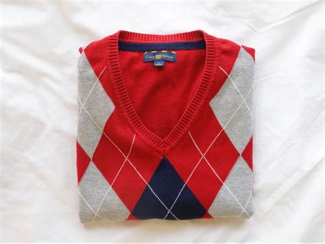 A Red Sweater Vest With A Grey And Navy Blue Argyle Print Handmade