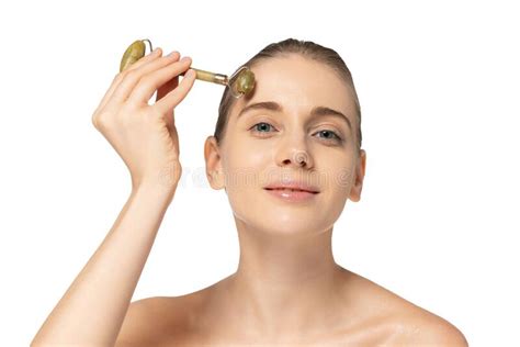 Portrait Of Young Beautiful Woman Taking Care After Skin Massaging Forehead With Cosmetic