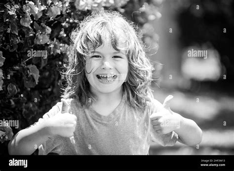 Portrait Of A Happy Laughing Child Close Up Positive Kids Face Thumbs