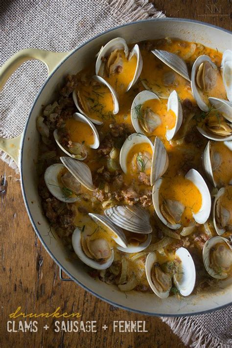 Clams And Sausage With Ferment In A Pan On A Wooden Table Top