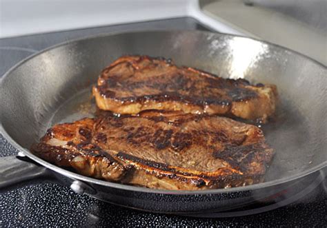 As soon as it starts to smoke, it is ready to have the steaks added. Perfect Pan-Fried New York Strip Steak | Mydeliciousmeals.com