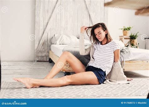Beautiful Young Feminine Woman Relaxing In Bedroom In Lazy Weekend
