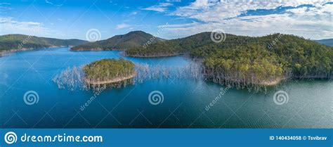 Panorama Of Bare Trees Growing In Water And Mountains Stock Photo