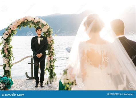 Father Leads The Bride To The Altar Where The Groom Is Waiting For Her