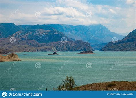 Turquoise Mountain Lake Among Brown Rocks And Sand Stock Photo Image
