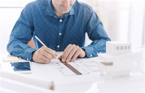 Professional Architect Working At Office Desk He Is Drawing With A
