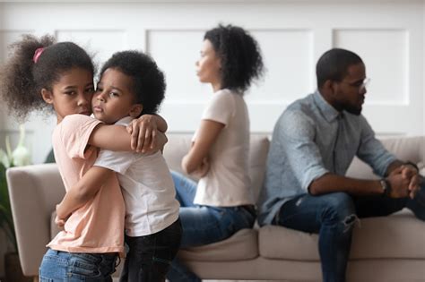 Sad African Children Embracing Upset At Parents Fight At Home Stock