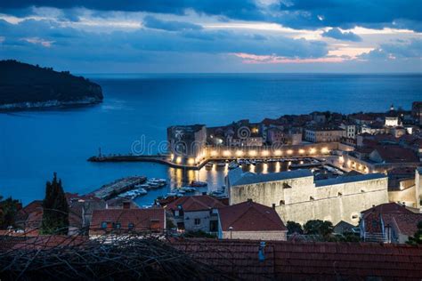 Dubrovnik Aerial Night View On The Harbor After Sunset With Dramatic