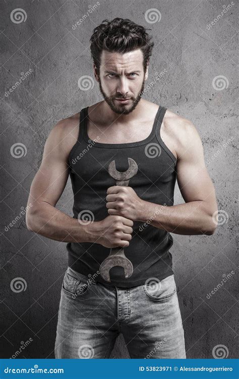 Handsome Rough Man Holding A Wrench Over A Textured Background Stock Image Image Of Male