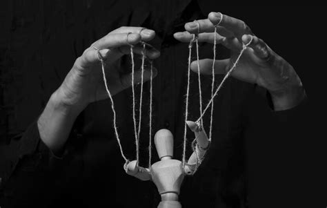 Premium Photo Hands Manipulating Puppet Master Of Marionette In Action