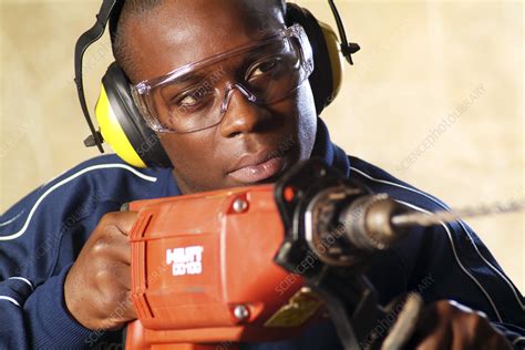 Using an electric drill - Stock Image - T840/0508 - Science Photo Library