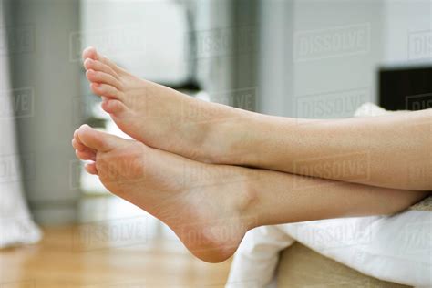 Woman S Bare Feet Legs Crossed At Ankle Stock Photo Dissolve