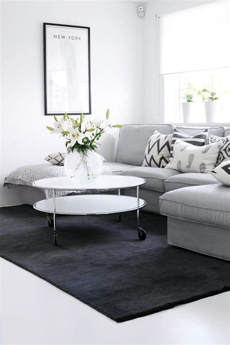 The simplicity is coming from the regular shapes of the furniture, the good organization of elements in the room and the free space around. Dark grey rug, Grey sofas and Grey rugs on Pinterest