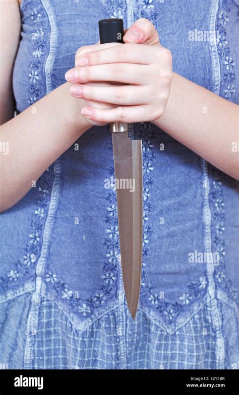 Woman Holding Large Kitchen Knife By Two Hands Stock Photo Alamy