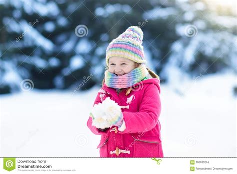 Child Playing With Snow In Winter Kids Outdoors Stock