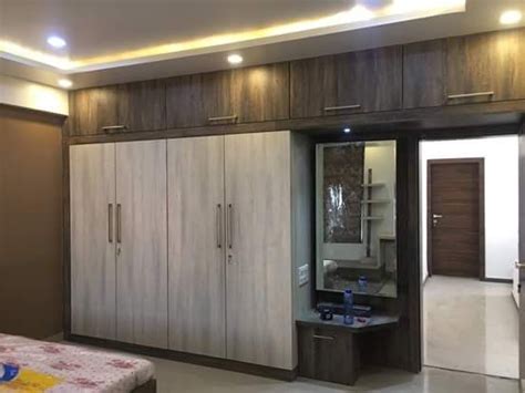 The designer for this wardrobe has used a wood patterned panel near the handles to make it look customised. walldrop design 2018 | Bedroom cupboard designs, Cupboard ...