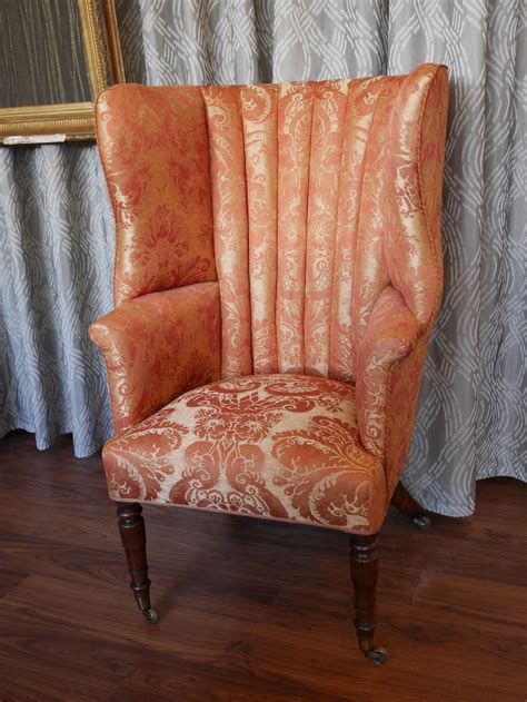 Tall Fluted Back Winged Armchair Upholstered With Salmon Damask Fabric By London Upholsterers