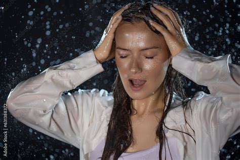 Young Woman In The Rain Getting Wet Through Wet Clothes And Water