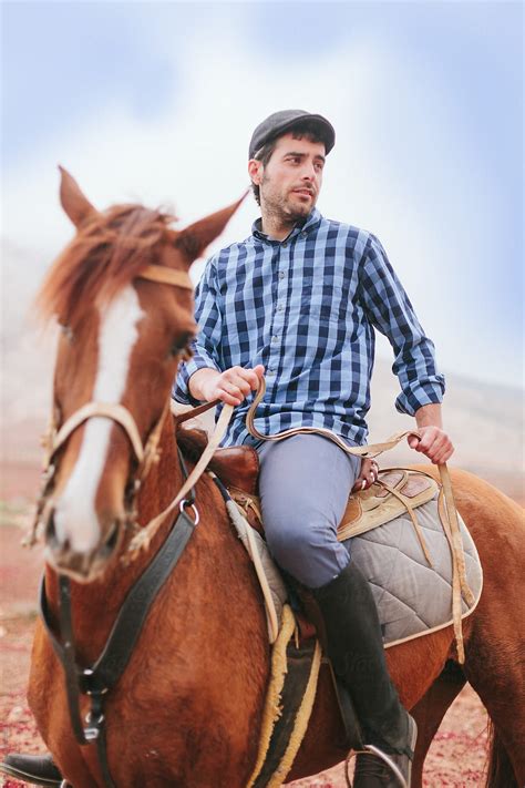 Man Riding A Horse In A Desert Area Del Colaborador De Stocksy