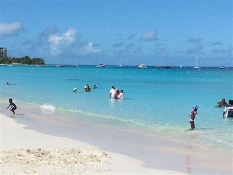 Many People Are On The Beach And In The Water At This Point There Is