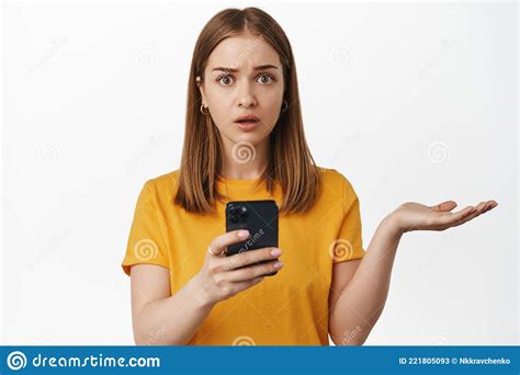 Puzzled Young Woman Holding Phone Cant Understand Shrugging And Looking Clueless Concerned
