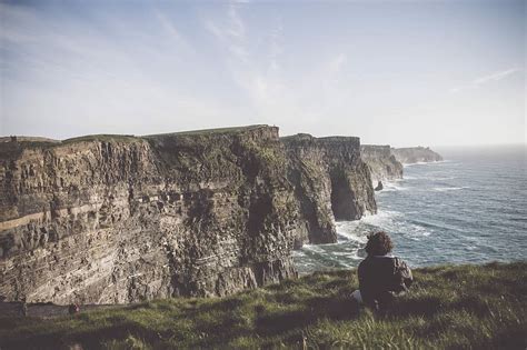 Hd Wallpaper Photo Of Cliff Near Sea During Daytime Person Sitting On
