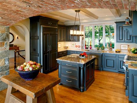 The metallic accents and appliances add a little sparkle to the elegant cooking space. Rustic Kitchen with Exposed Brick and Blue Cabinets | HGTV