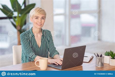Entrepreneur Woman Working On Laptop Sitting At Workplace Indoor Stock