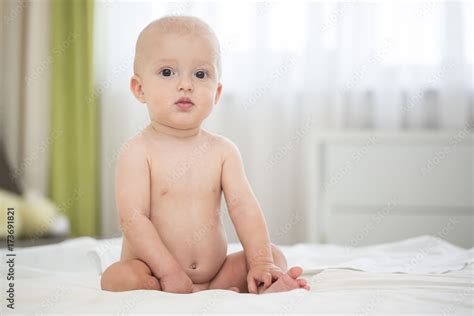 Cute Naked Baby Boy Sitting On Bed Stock Photo Adobe Stock