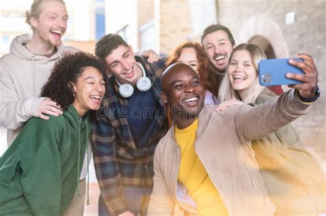Multiracial Young People Group Taking Selfie With A Smartphone Happy