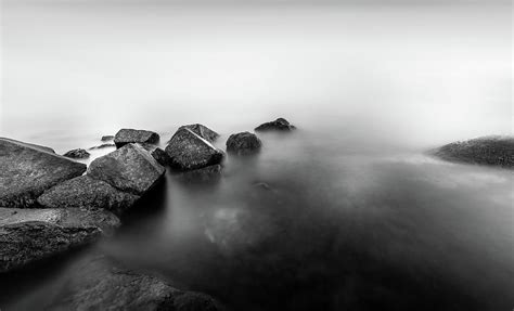 rocks in smooth water photograph by nicklas gustafsson pixels