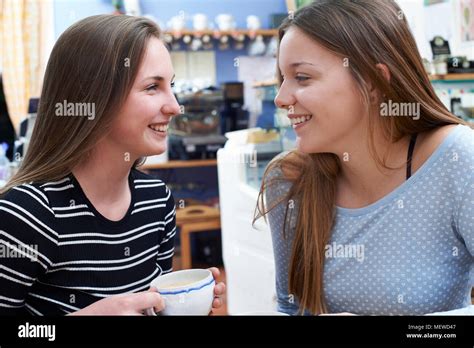 Two Female Teenage Friends Meeting In Cafe Stock Photo Alamy