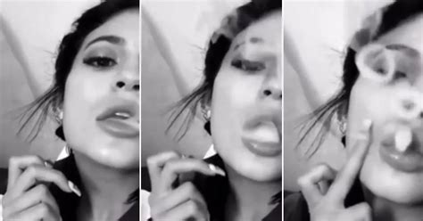 kylie jenner blows smoke rings as she taps her cheek and exhales on e cigarette in snapchat