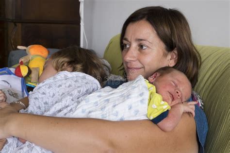 Mother Holding Her Newborn Son And 3 Year Old Daughter In Her Arms Stock Image Image Of Face