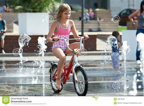 I'm not the crying type. Little Girl Rides His Bike Among Fountains Stock Photo ...