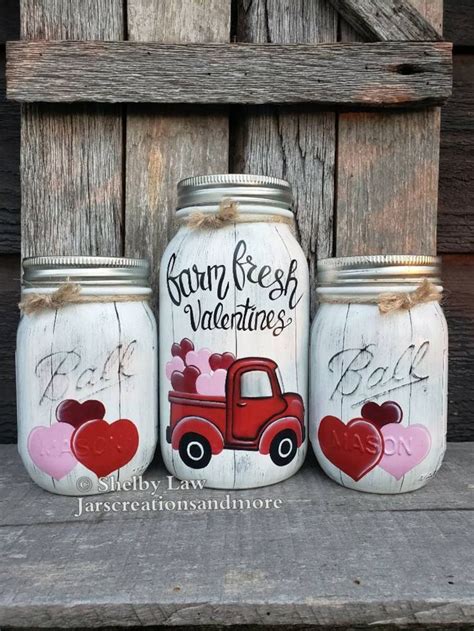 Three Mason Jars With Hearts Painted On Them
