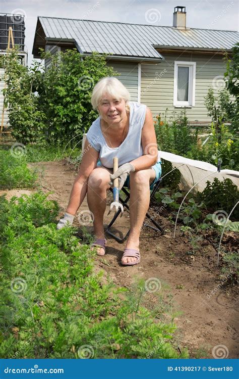 Mature Woman Sitting On A Chair Of His Garden Stock Image Image Of