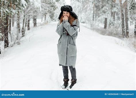 Beautiful Young Woman Standing Among Snowy Trees In Winter Forest And