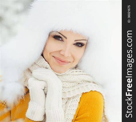 Winter Portrait Of Beautiful Smiling Woman With Snowflakes In White