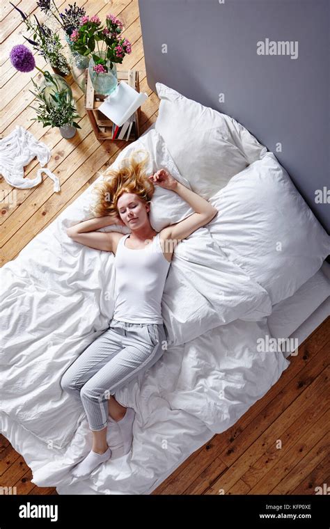Young Attractive Woman Stretched Out On White Bed Morning Atmosphere