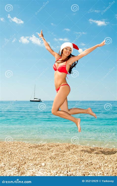 Santa Girl In A Bathing Suit And Hat Against The Sea Stock Image