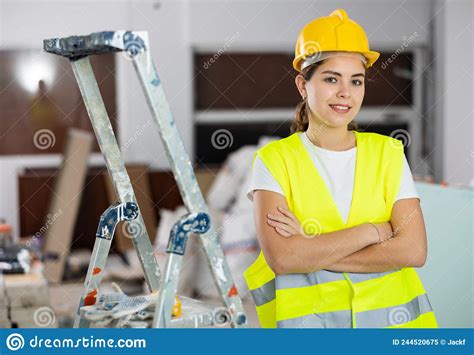 Confident Smiling Female Civil Engineer With Crossed Arms At